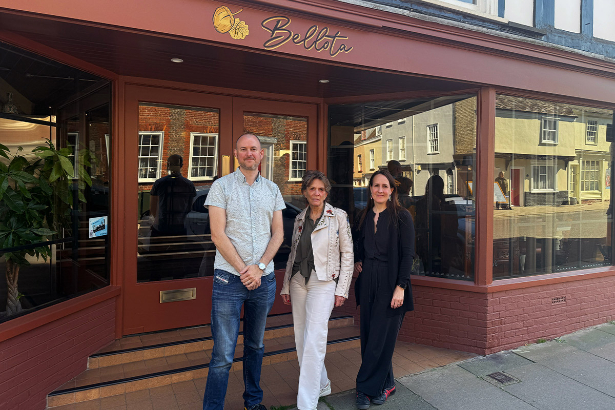a man and two women standing outside bellota in churchgate street bury st edmunds.